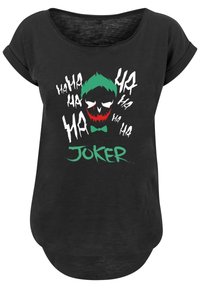 Svart t-skjorte med rullet erme som har et grafisk trykk av et klovneskjelett med grønt hår, røde lepper og teksten "JOKER" i grønt.