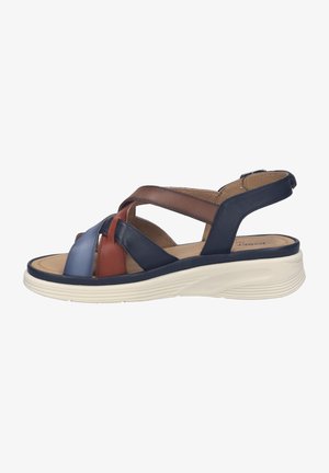 Sandalo da donna con suola bianca imbottita e cinturini in pelle incrociati nei colori blu, marrone e ruggine, con cinturino regolabile alla caviglia.