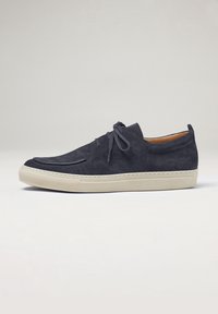 Sneaker in suede di colore blu scuro con punta rotonda, lacci tonali, suola in gomma beige e dettagli di cucitura lungo il lato. Design minimalista.