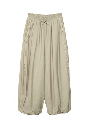 Voľné béžové široké nohavice s elastickým pásom, šnúrkou na stiahnutie, bočnými vreckami a cvokmi pozdĺž vonkajších švov.