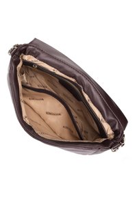 Brązowa skórzana torebka o gładkiej fakturze. Posiada zamek błyskawiczny oraz beżową podszewkę z nadrukowaną marką "WITTCHEN".