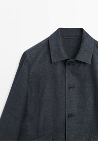 Dark gray button-up jacket with a classic collar, three visible black buttons, and textured fabric on a white background.