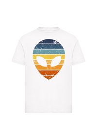White cotton T-shirt featuring a distressed graphic of an alien head with horizontal stripes in navy, teal, yellow, and orange.