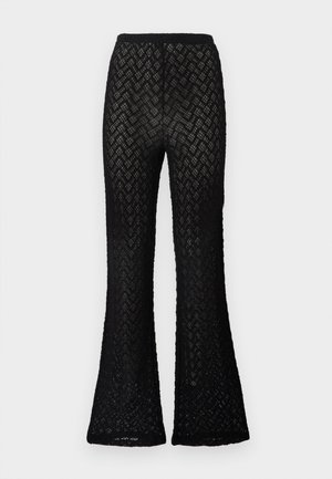 Schwarze Spitzenhose mit Zickzackmuster und ausgestellten Beinen, ausgestattet mit einem elastischen Bund.