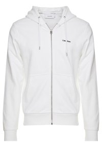 Vit zip-up hoodie med framfickor, dragsko för huvan och liten svart Calvin Klein-logga på vänster bröst.