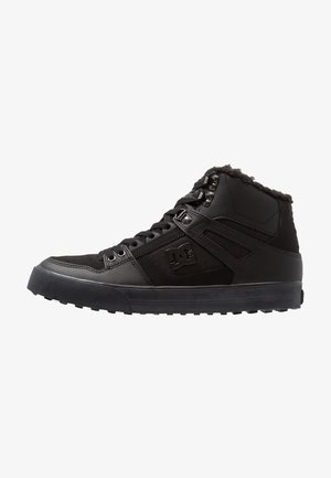 Black high-top sneaker with a leather and suede upper, featuring a textured finish, round toe, padded collar, and rubber sole.