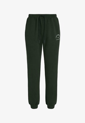 Dunkelgrüne Jogginghose mit elastischem Bund, Kordelzug, Seitentaschen, Bündchen an den Knöcheln und weißem Logotext am linken Oberschenkel.