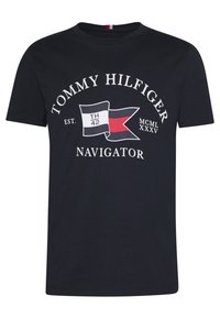 Navy blue cotton t-shirt featuring "TOMMY HILFIGER" logo, flag graphic, and text. Short sleeves and round neckline. Classic fit.