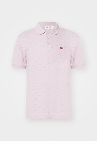 Světle růžová polo triko s límcem, třemi knoflíky a malými rozptýlenými diamantovými vzory. Na hrudi se nachází červené logo Levi's.