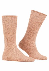 Hellrosa strukturierte Socken mit einem gesprenkelten Design in verschiedenen Schattierungen von Pfirsich und Rot. Rippenspitze und glatte Oberfläche.