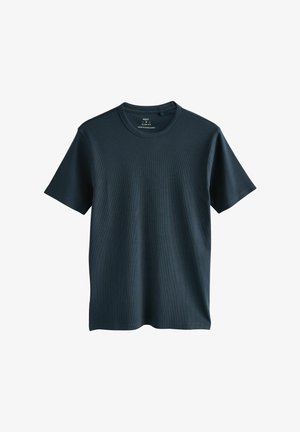 T-shirt ajusté bleu marine avec un col rond, en tissu côtelé. Manches courtes et ourlet droit. Étiquettes à l'intérieur du col.