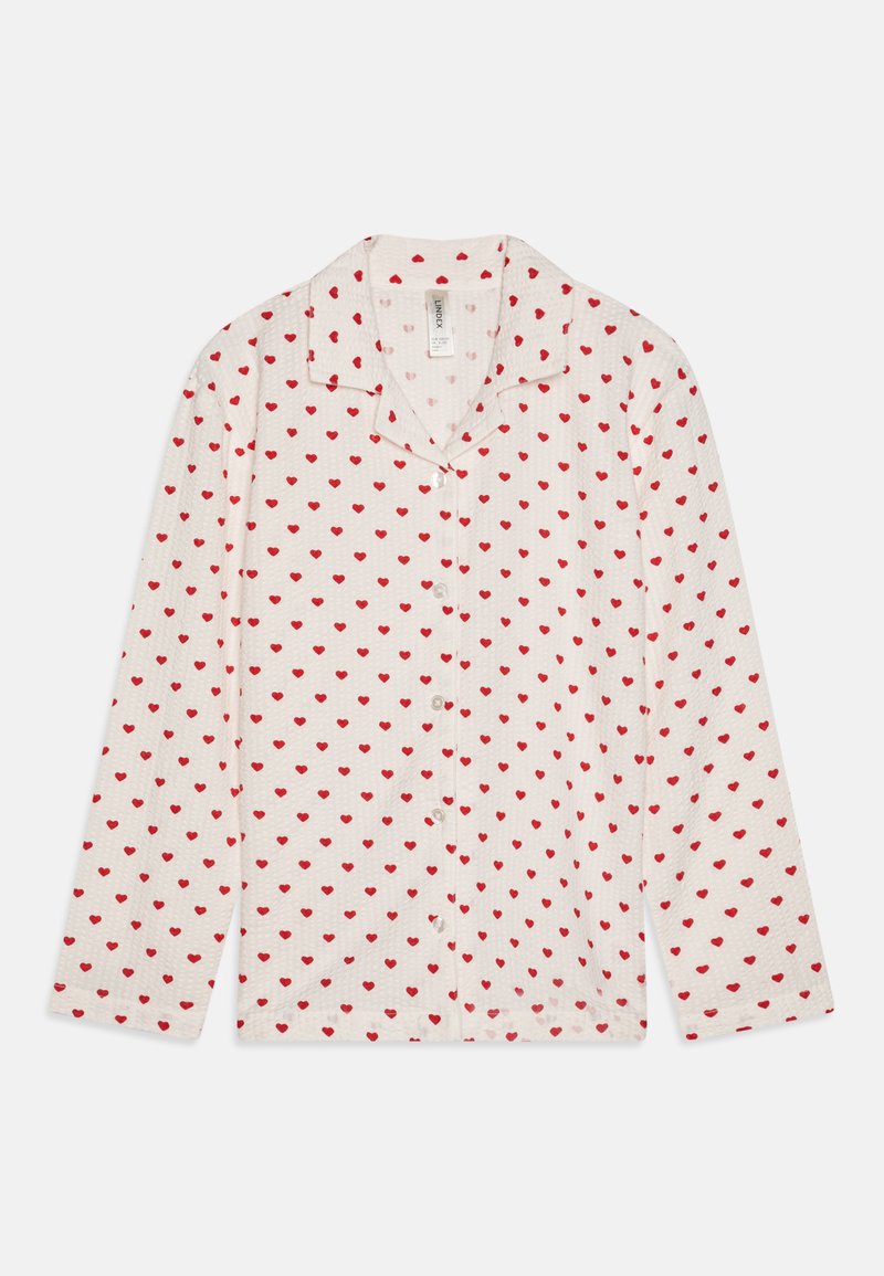 Witte blouse met lange mouwen, gekenmerkt door een patroon van kleine rode hartjes. Gemaakt van een lichtgewicht, gestructureerde stof.