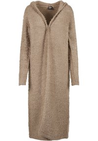 Beige pitkä neuletakki, joka on valmistettu pehmeästä, pörröisestä materiaalista. Siinä on huppu, avoin etuosa ja pitkät hihat. Malli on rento ja pinnassa on tekstuuria.