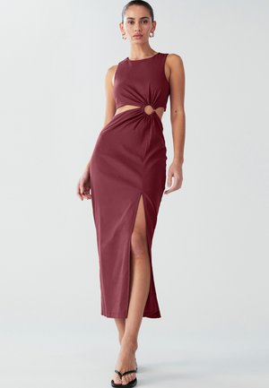 Robe maxi bordeaux avec découpe et détail torsadé à la taille, dotée d'une fente latérale et d'un design sans manches, réalisée en tissu lisse.