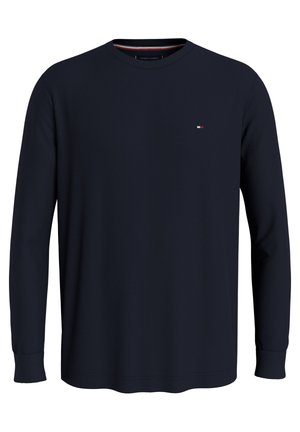 Marineblauwe longsleeve crewneck sweatshirt gemaakt van gestructureerde stof. Voorzien van een klein logo op de borst en geribbelde boorden. Eenvoudig, klassiek ontwerp.