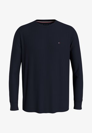 Sweat-shirt à col rond à manches longues de couleur marine, fabriqué en tissu texturé. Il présente un petit logo sur la poitrine et des poignets côtelés. Design simple et classique.