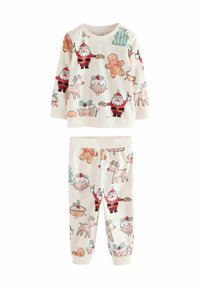 Two-piece children's pajama set in soft, cream-colored fabric. Features festive prints of Santa, gingerbread cookies, and reindeer.