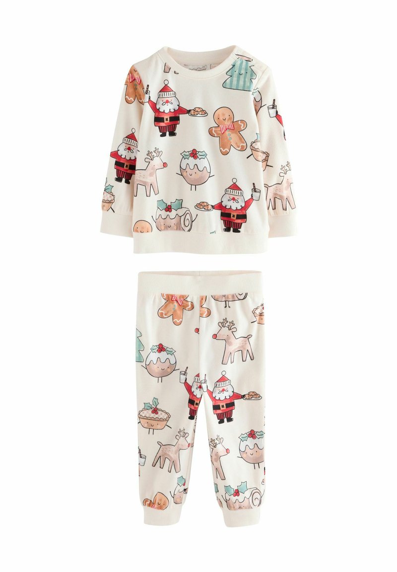 Two-piece children's pajama set in soft, cream-colored fabric. Features festive prints of Santa, gingerbread cookies, and reindeer.