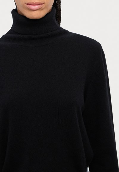 Black turtleneck sweater made of soft knit fabric, featuring a fitted collar and relaxed fit with long sleeves.