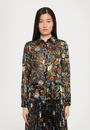 Blusa floreale nera trasparente con fiori ricamati colorati, colletto e chiusura con bottoni sul davanti. Maniche lunghe con polsini.
