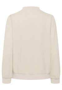 Jachetă bomber bej deschis, cu un model floral texturat, guler și manșete ribbate, și o croială dreaptă. Oferă un material moale, țesut.