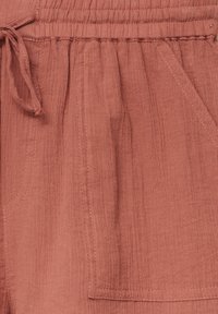 Rostkleurige shorts van gestructureerde stof met een elastische tailleband, trekkoorddetail en een voorzak.
