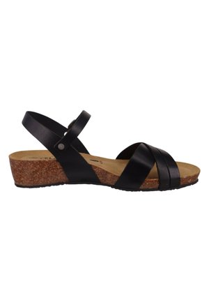 Sandale compensée en cuir noir avec des brides croisées à l’avant, bride à la cheville avec boucle et semelle en liège sur fond blanc.