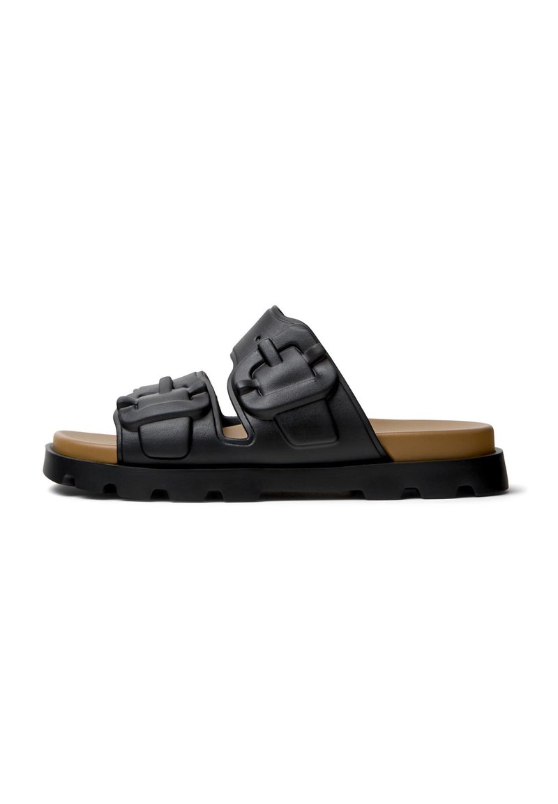 Black slide sandal made of textured rubber, featuring two padded straps with accent details, and a contrasting brown footbed on a durable sole.