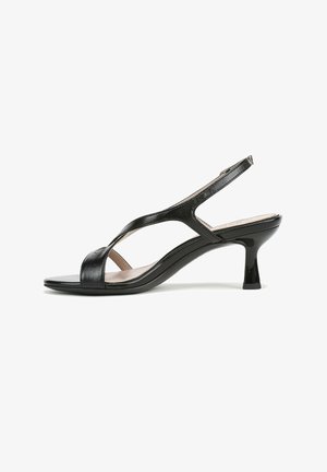 Sandalo slingback in pelle nera con punta aperta, caratterizzato da un design curvo e un tacco corto a blocco per la stabilità. Texture liscia e dettagli minimalisti.