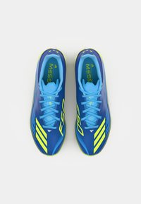Blue soccer cleats with yellow accents, featuring a smooth synthetic upper, prominent "F50" branding, and a lace-up design.