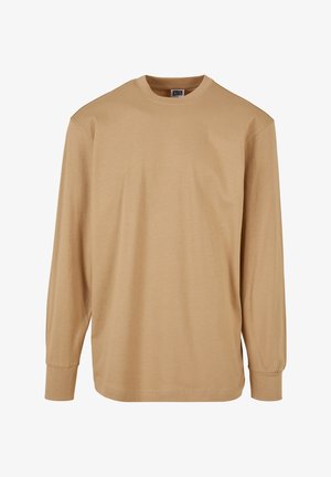 Hosszú ujjú, kerek nyakú póló világos bézs színű pamutból, sima textúrával és normál szabással, ribbelt mandzsettával és hem.