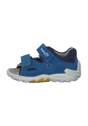 Blue, velcro-strap sandal made of fabric with a rubber sole. Features cutouts for breathability. Accented with a smiley face logo.