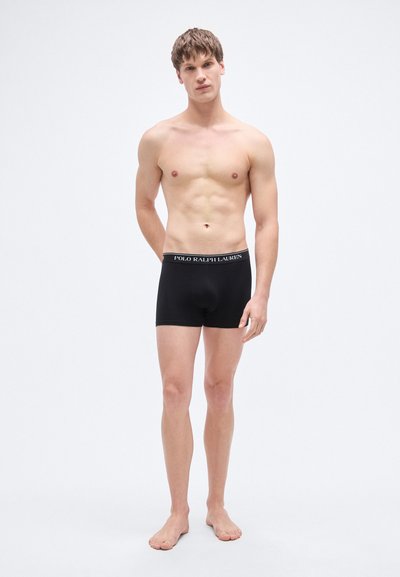 Crne bokserice od pamuka s pojasom na kojem je otisnut logotip. Standardan kroj, glatka tekstura, pružaju pokrivenost i udobnost.