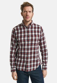 Rote, marineblaue und weiße Karomuster-Flanelljacke mit langen Ärmeln, Button-Down-Kragen und einer Brusttasche. Mit abgerundetem Saum und Knopfverschluss.