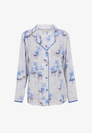 Witte pyjama top met een blauw zebra- en palmboomprint. Voorzien van een knoopsluiting aan de voorkant, een kraag en blauwe biesjes langs de randen. Lange mouwen.
