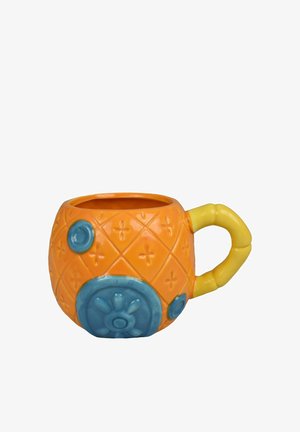 Orange ceramic mug shaped like a pineapple with blue decorative circles and a yellow handle resembling bamboo.