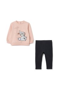 Sweatshirt rose avec un graphique de lapin et du texte, associé à un legging noir. Les deux vêtements sont en tissu doux avec une texture lisse.
