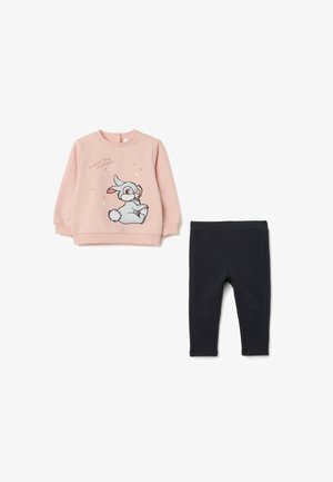Roze sweatshirt met een konijnafbeelding en tekst, gecombineerd met zwarte leggings. Beide kledingstukken zijn gemaakt van zachte stof met een gladde textuur.