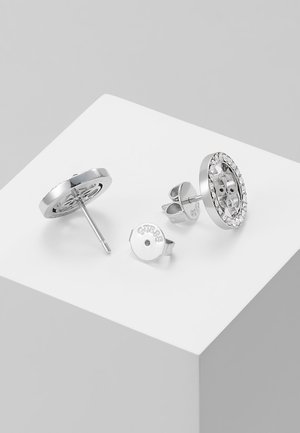 Silver-tone circular stud earrings with clear rhinestones around the edge, displayed with metal butterfly backings on a white surface.