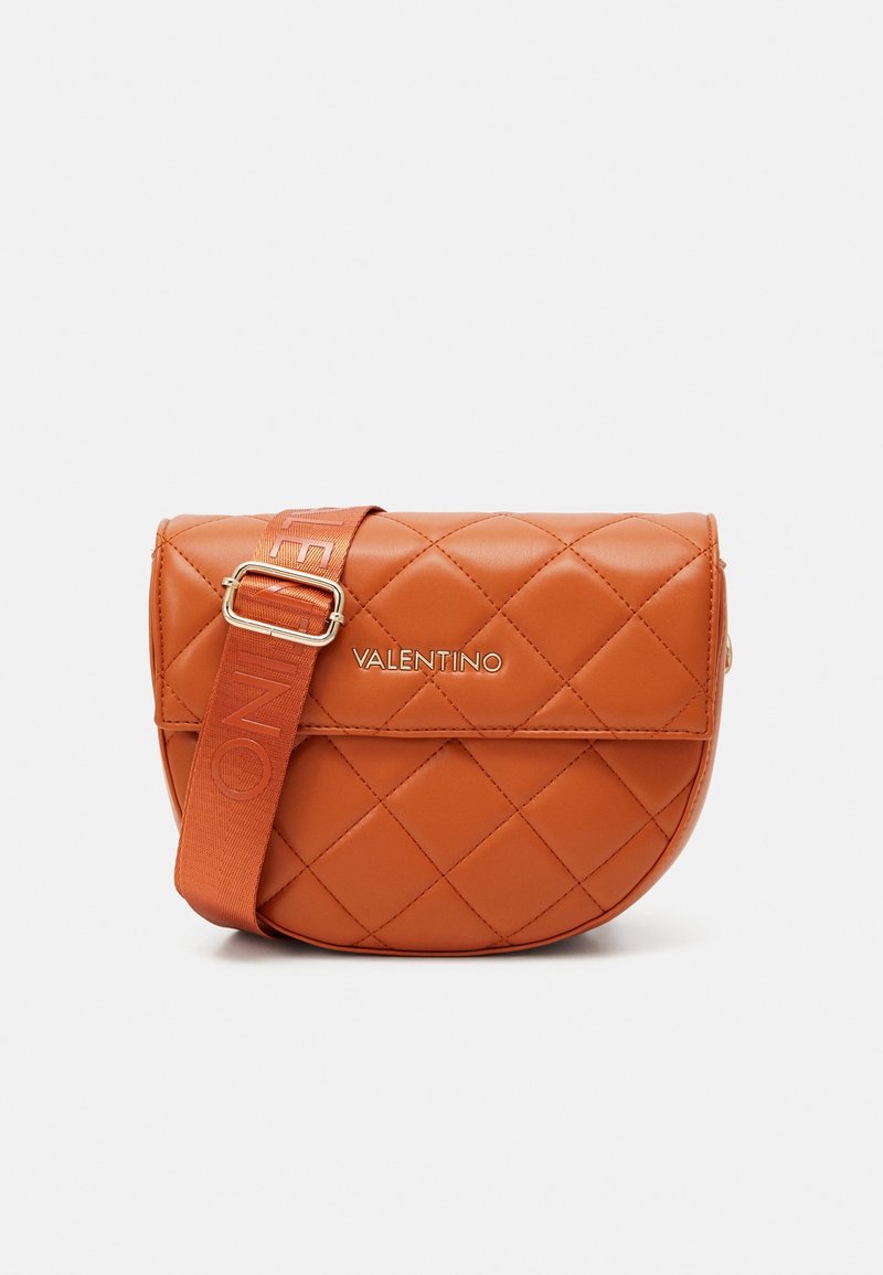 Quilted orange leather crossbody bag with a glossy finish, featuring a gold-tone logo and a patterned adjustable strap.