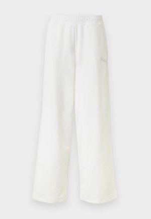 Pantalon de survêtement blanc à coupe ample avec une taille élastique et un logo discret sur le côté de la cuisse droite.