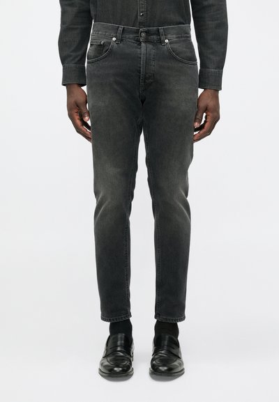 Black denim jeans with a slim fit, five pockets, and a faded finish. Features a standard button closure and contrasting stitching.