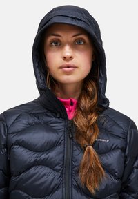Navy puffer jacket with a fitted hood and zigzag quilting, featuring a zipper closure and a pink interior lining.