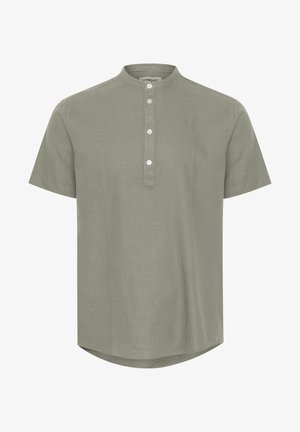Short-sleeved, light green shirt with a mandarin collar, four-button placket, and rounded hem; made from a smooth, textured fabric.