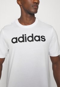 adidas Sportswear ESSENTIALS SINGLE LINEAR EMBROIDERED - Apdrukāts T-krekls - white /black