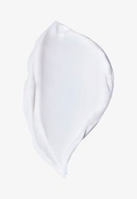 Thick, creamy, white lotion swatch with a smooth texture, showing a curved edge and glossy surface against a plain background.