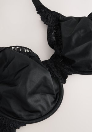 Must rinnahoidja, millel on siledad satiinkupud ja pitsiline ääris. Disain sisaldab tugikaari ja reguleeritavaid rihmasid õrna mustriga.