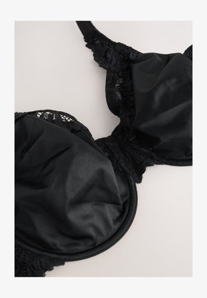 Must rinnahoidja, millel on siledad satiinkupud ja pitsiline ääris. Disain sisaldab tugikaari ja reguleeritavaid rihmasid õrna mustriga.