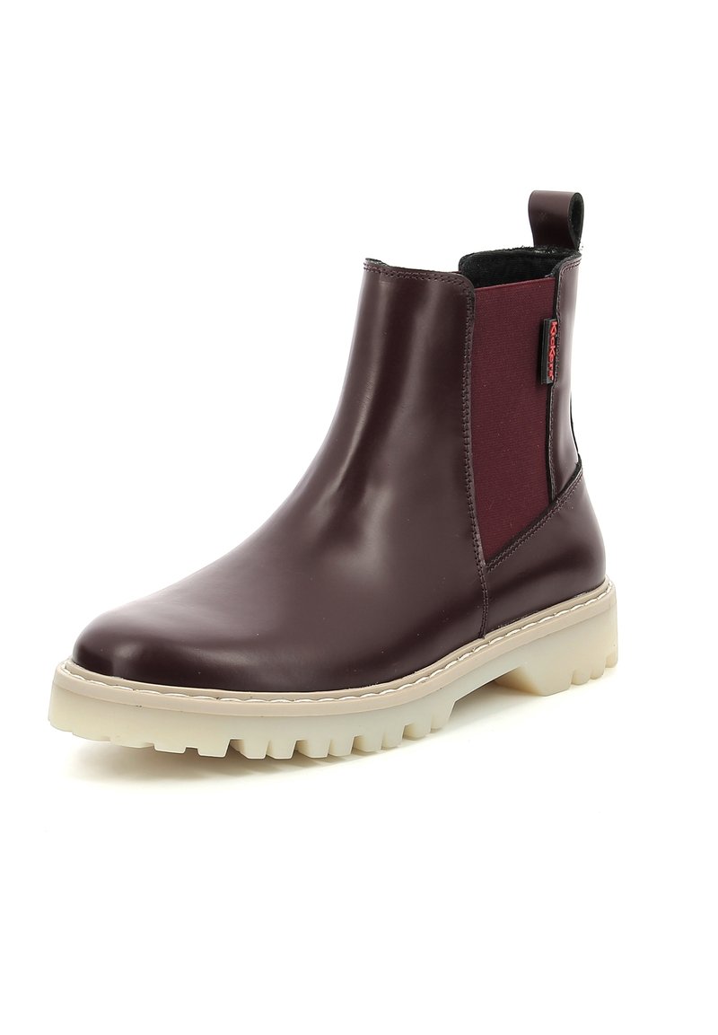 Bottines en cuir brun avec des panneaux latéraux élastiques et une languette. Elles présentent une semelle en caoutchouc blanc épais avec un motif à crampons pour une meilleure adhérence.