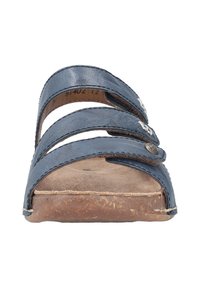 Navy blue leather slide sandal with three cross straps, cork-like sole, and metal accents on the straps. Flat design with no heel.